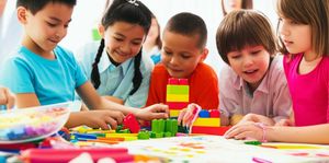 Children collaborating on a creative project in a bright classroom, fostering imaginative problem-solving.