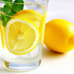 Refreshing Lemon water with slices of fresh lemon and mint.
