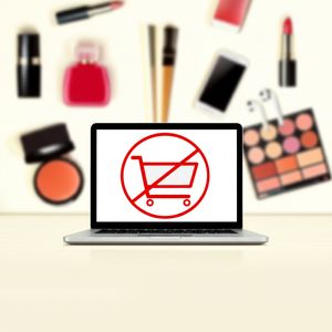 Illustration of 'De-influencing' showing a crossed-out shopping cart on a laptop, symbolizing conscious consumer choices.