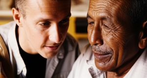 Traveler and local artisan sharing a genuine moment of connection over a handmade craft, symbolizing cultural exchange.
